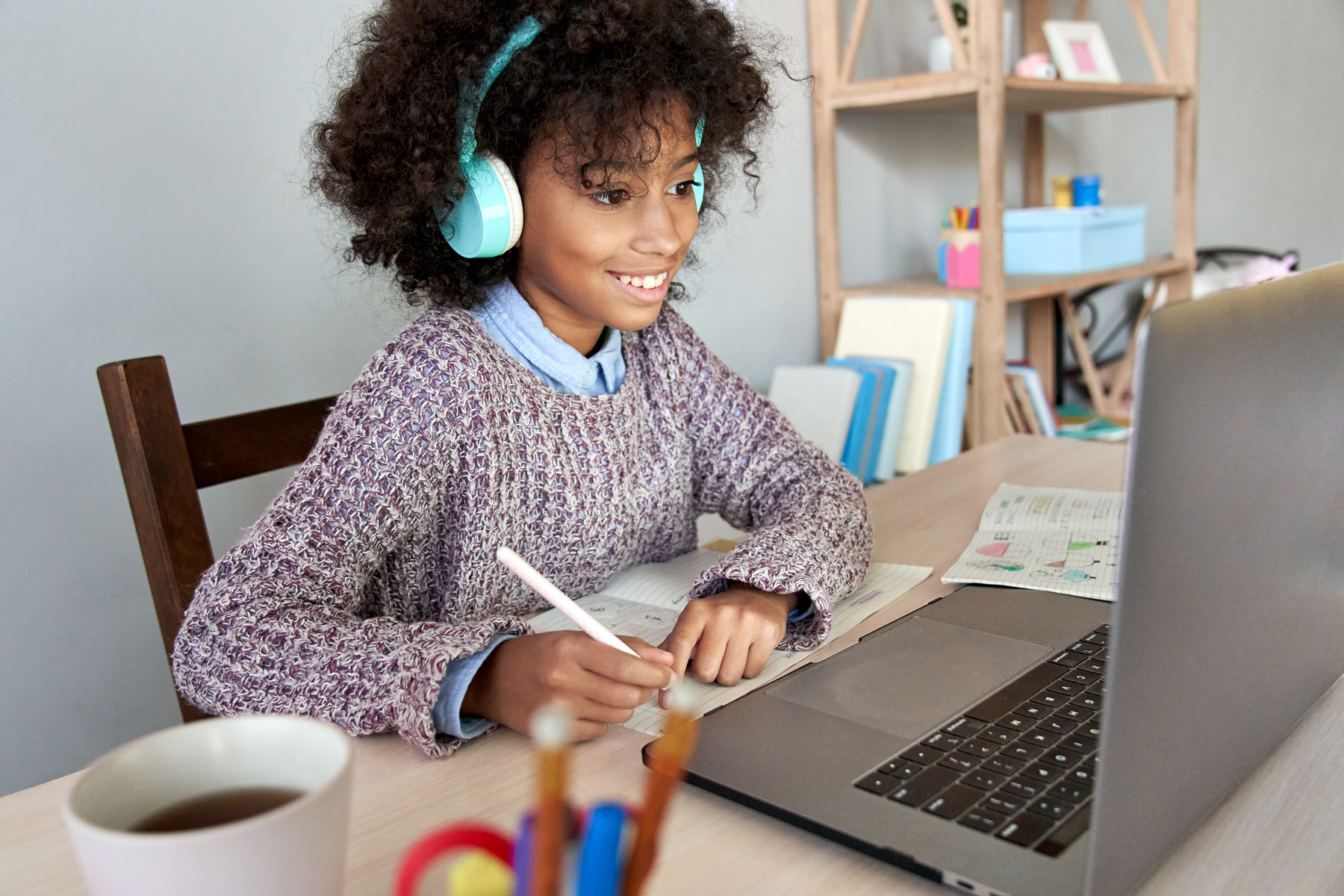 African School Child Girl Wearing Headphones Virtual Online Learning at Home.