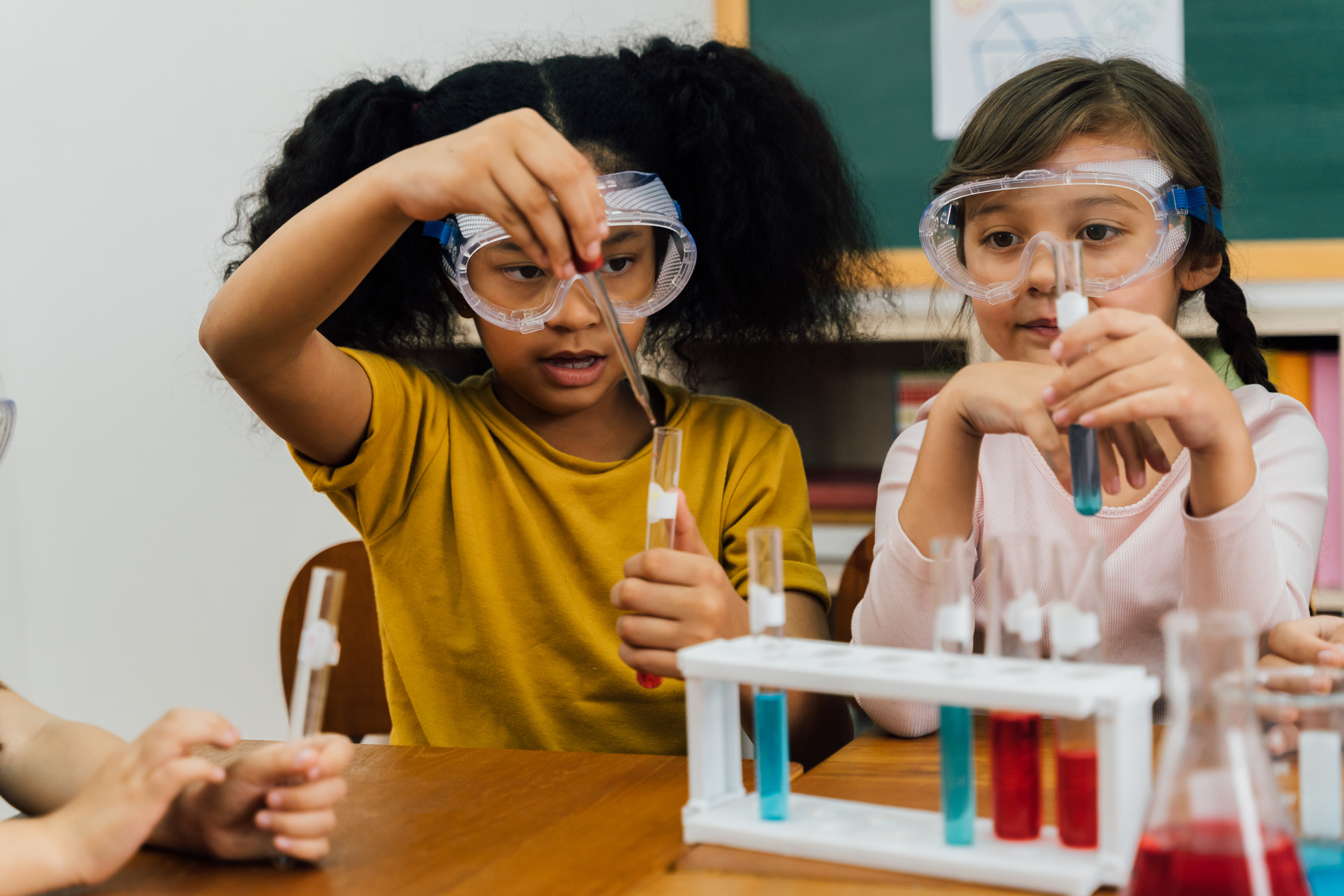 Diverse Girls Conducting Science Experiment at School